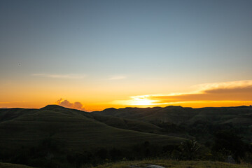Evening in the Sumba Savanna unites the rolling hills, an ancient church, and a golden sky
