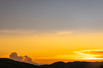 Evening in the Sumba Savanna unites the rolling hills, an ancient church, and a golden sky