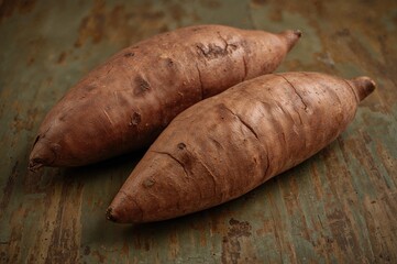 Sweet potatoes roasted in the oven on rustic wooden surface