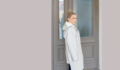 Woman opening doors of house (hotel, store)
