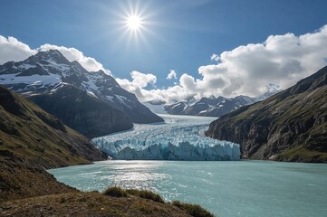 Obraz premium Snow-covered dark rocks under a radiant chilly sun. Glacier meltwater shines with a vivid blue hue.
