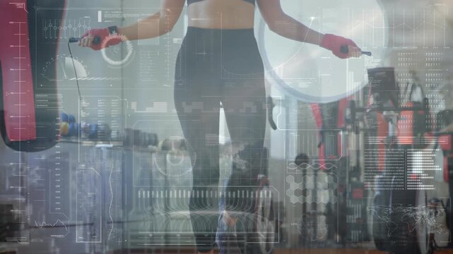 Animation of data processing over caucasian female boxer jumping rope at gym - Powered by Adobe