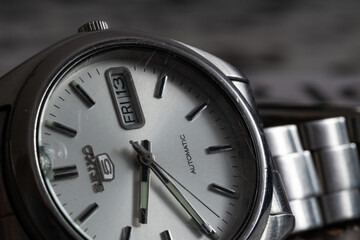 Close up of wrist watch with broken and scratched glass, automatic movement