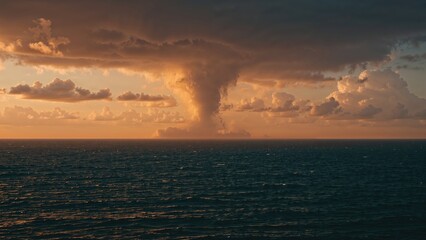 Twisting waterspout visible at sunset over the ocean, showcasing dramatic climate change impacts.
