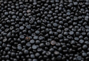 Close-up of dark, shiny black beluga lentils, scattered on a surface,  simple,  cooking