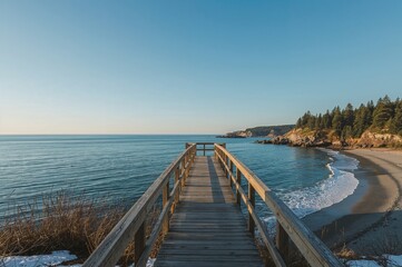 Obraz premium Scenic wooden bridge over winter waters with beach and sky views