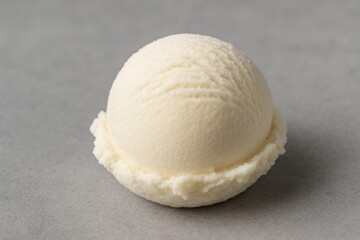 Smooth vanilla ice cream sphere on a gray surface