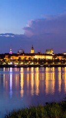 Obraz premium City skyline at twilight reflected on river (1)