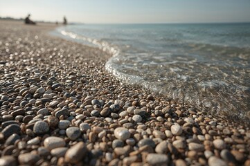 Tiny stones scattered on the shore in the afternoon sun