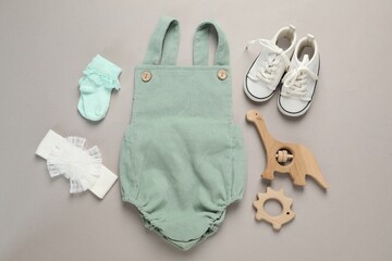 Stylish baby clothes and accessories on grey background, flat lay