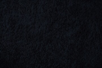 Fototapeta premium Top-down view of a continuous black rug surface with detailed fabric pattern