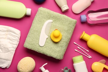 Baby bath accessories and care products on crimson background, flat lay