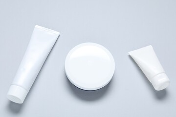 Cosmetic products on light background, flat lay. Mockup for design