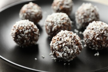 Tasty chocolate candies with nuts on light table, closeup