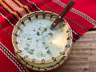 Traditional Bulgarian tarator soup in ceramic pot in a restaurant 