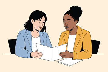 Fototapeta premium Two women reviewing documents at a table papers reading