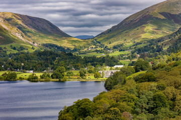 Dramatic clouds over the green fells and valley of Grasmere on a summer day