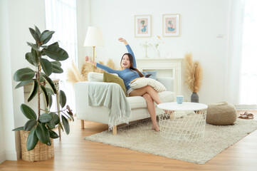 Young Asian woman relaxing in living room at home