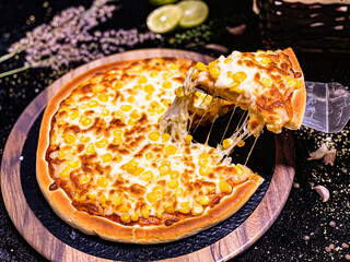 Hot pizza with stretchy melted cheese pulling from a slice, delicious and tempting.
