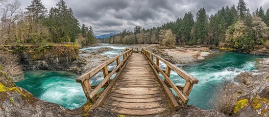 Scenic Wooden Bridge Over Rapid Turquoise River Flowing Through Forest