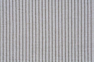 A horizontal macro shot of a light gray fabric with a vertical striped weave, can be used as a...