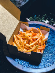 French fries being deep-fried in hot oil, crispy and golden snack.