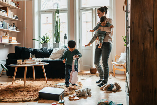Mother spending leisure time with kids at home