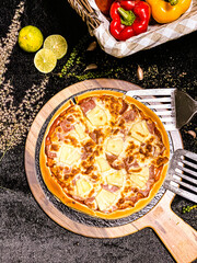 Hawaiian pizza topped with pineapple, bacon, and melted cheese, delicious and savory.