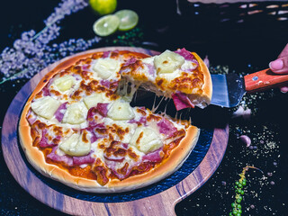 Hawaiian pizza topped with pineapple, bacon, and melted cheese, delicious and savory.
