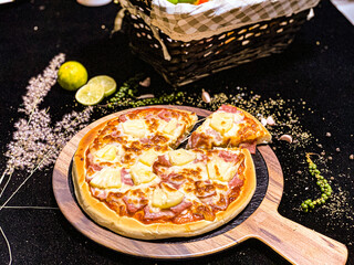 Hawaiian pizza topped with pineapple, bacon, and melted cheese, delicious and savory.