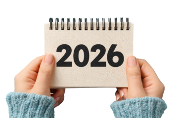 Hands holding a small spiral-bound notepad displaying the year 2026