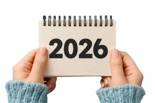 Hands holding a small spiral-bound notepad displaying the year 2026