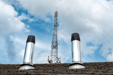 Abstract view of two newly installed metal vents used for a hospital backup power system. In the...