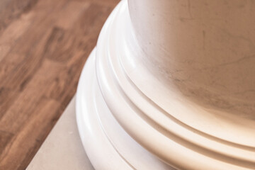 Detailed view of a classic white marble column base