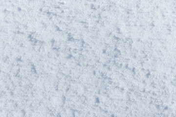 White snow relief texture with sharp shadows, background photo texture