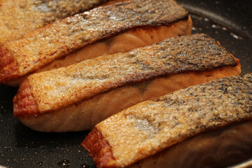 Closeup of Seared Salmon Fillets Skin Side Up