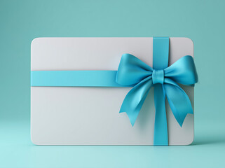White gift card with a shiny blue ribbon bow on turquoise background.