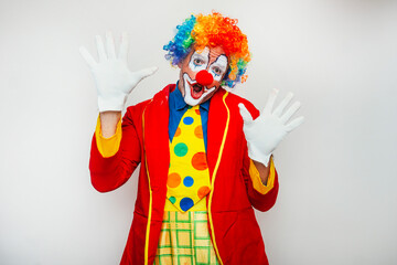 Clown raising hands in comic surprise