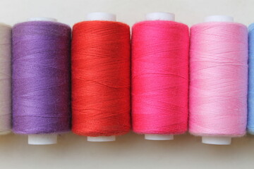 Sewing Threads in Various Colors on White Background