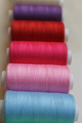 Close Up of Colorful Sewing Threads in a Row