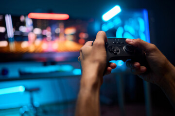 Enjoying an exciting gaming session with a controller and large screen for immersive gameplay