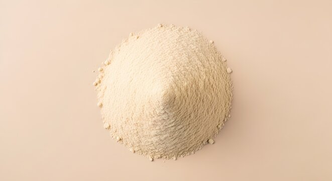 Top-down view of a conical pile of light beige fine powder, a versatile ingredient or abstract texture on a minimal studio background.