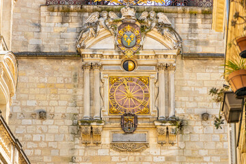 Clock of the Grosse cloche in the center of Bordeaux, France on a sunny day