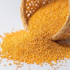Golden millet seeds spill from a woven basket