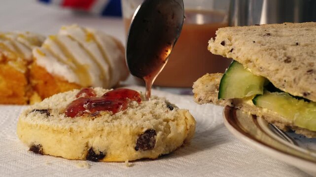 Traditional English tea with jam scone and cucumber sandwiches