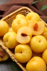 Ripe yellow cherry plums on wooden table, closeup