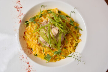 Savory Risotto with Tender Chicken and a Fresh Peas Garnish for An Elegant Dining Experience