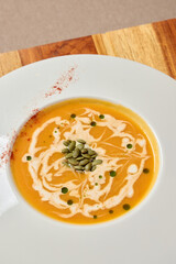 Indulge in a Delicious Creamy Pumpkin Soup, Perfectly Prepared with Colorful Garnishes