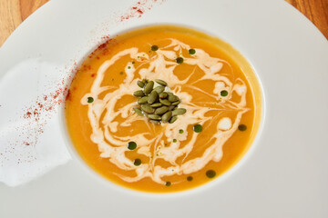 Experience the Delicious and Creamy Pumpkin Soup with Artistic Presentation to Delight
