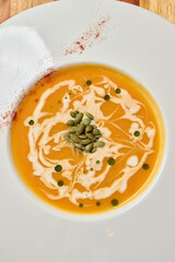 A Delicious and Creamy Pumpkin Soup with a Beautiful Seeds Garnish for Enjoyment